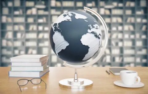 wooden-desktop-with-globe-coffee-books-and-glass-2026-01-11-08-47-12-utc